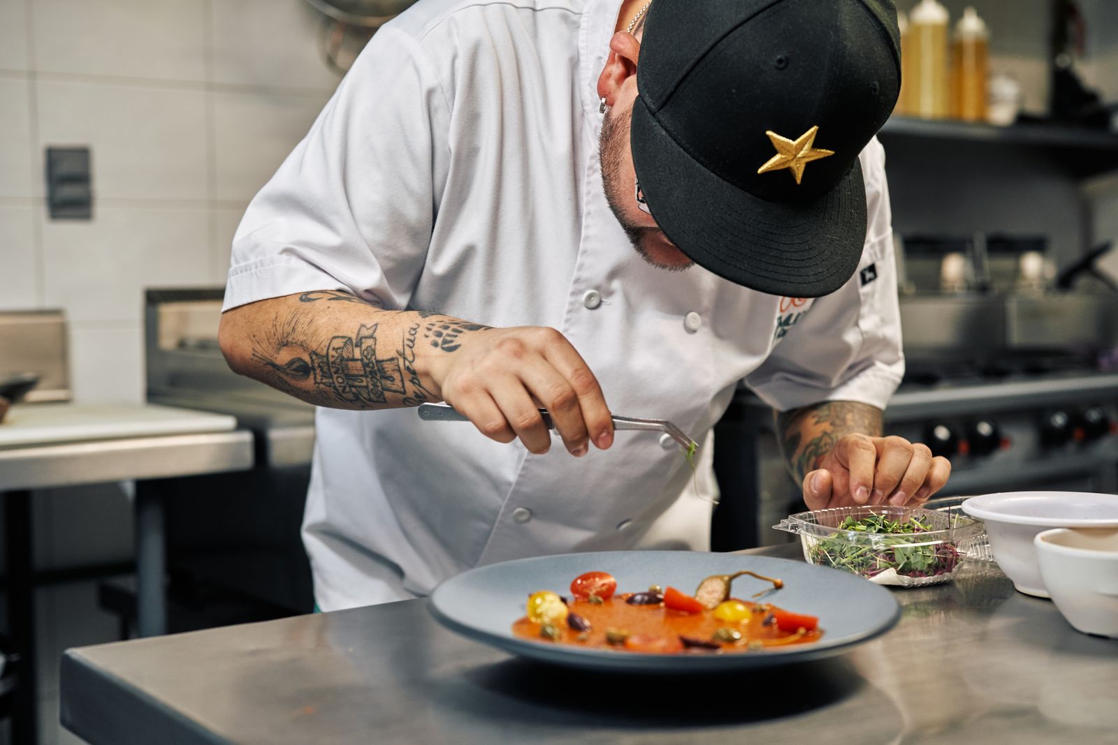 A chef garnishing a gourmet dish