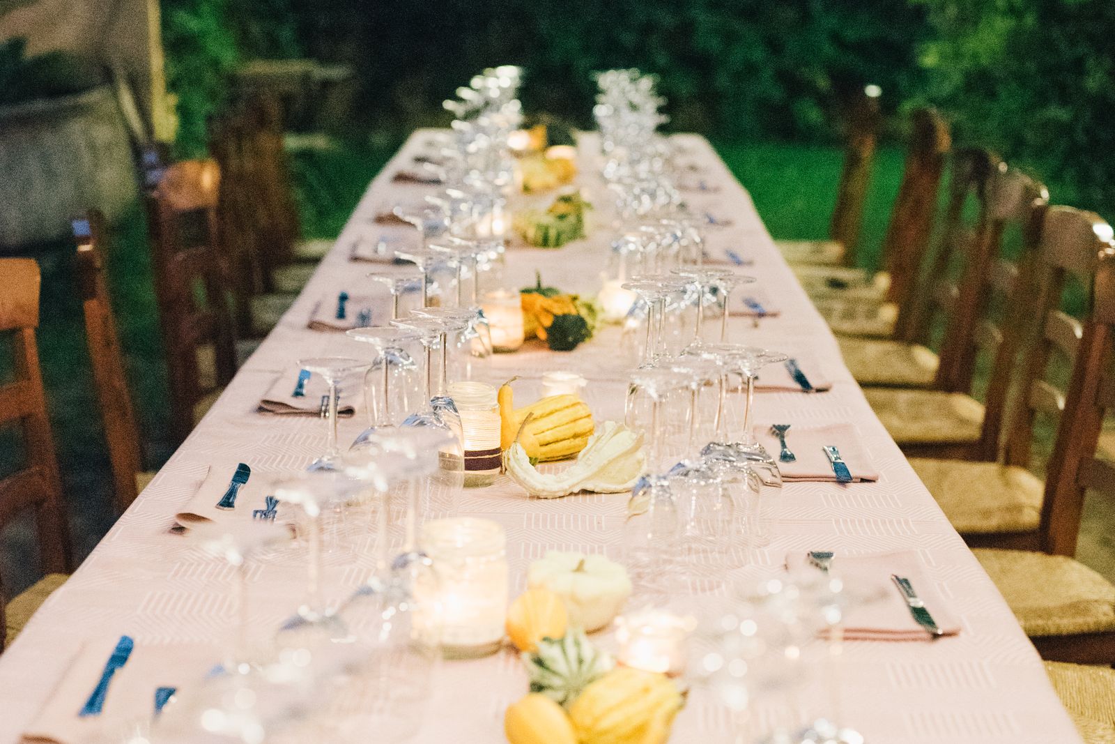 An outdoor table set with candles for a celebration